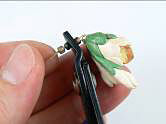 Beads on wire attached to clay flowers
